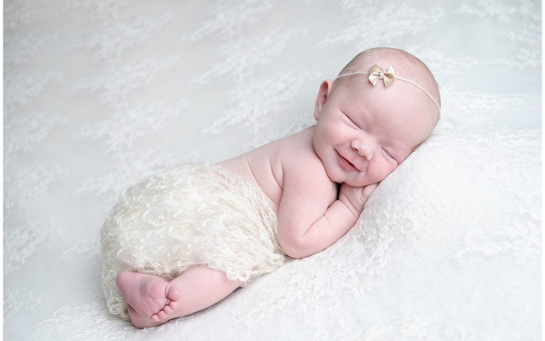 Newborn baby smiling during a Dorset newborn photoshoot