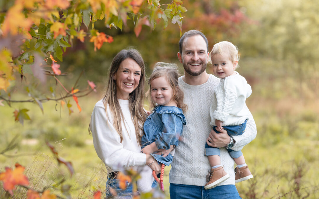 Happy smiling family in an autumn mini family photo shoot