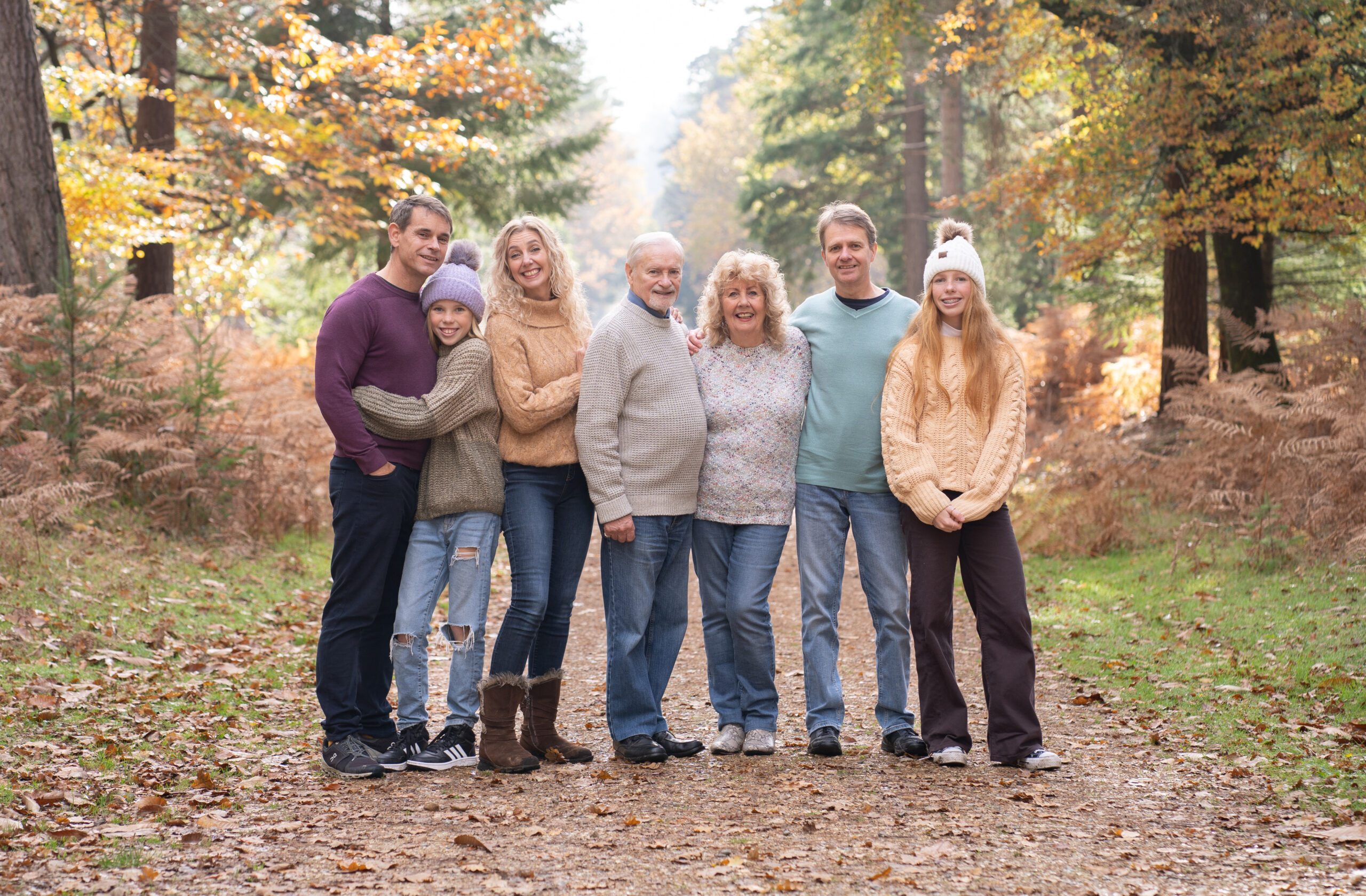 Extended happy family on an autumn mini session in the new forest with bournemouth family photographer