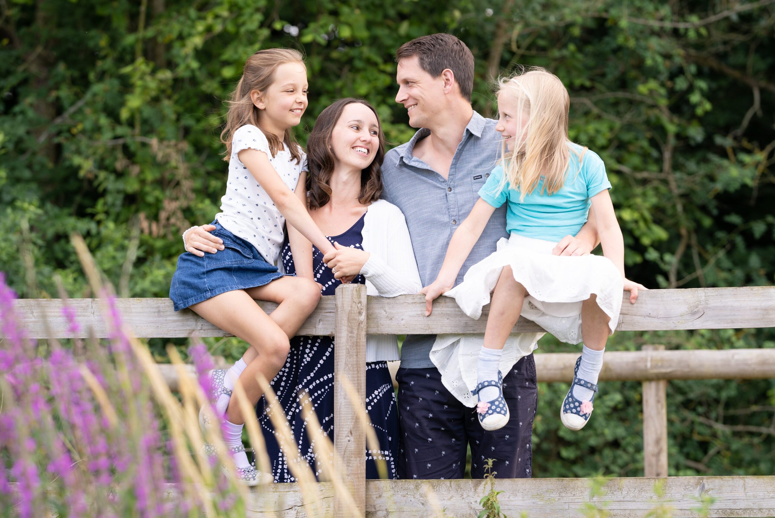 Happy family looking at each other during shoot with Ferndown family photographer