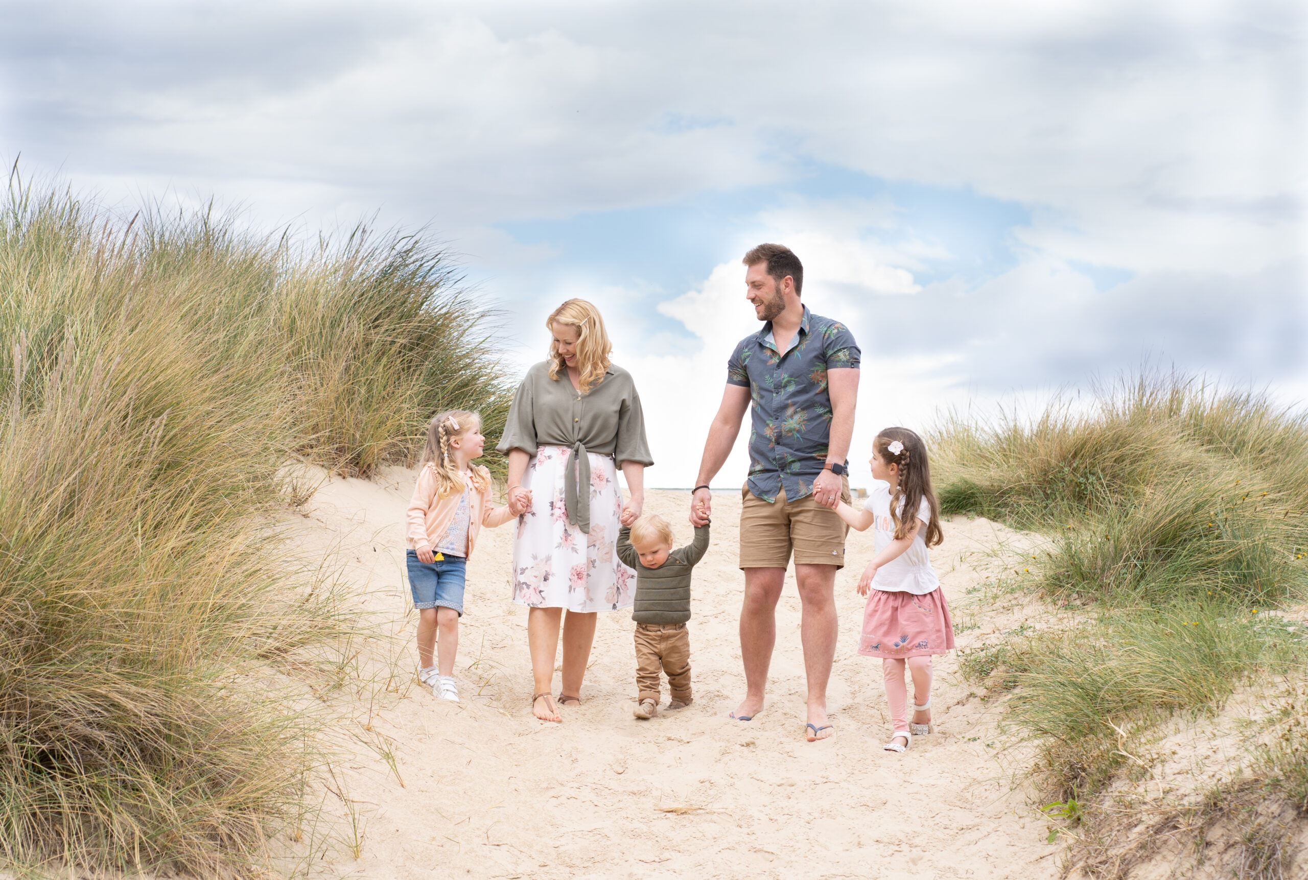 Happy family with small children at sandbanks beach during a spring mini photo shoot with bournemouth photographer