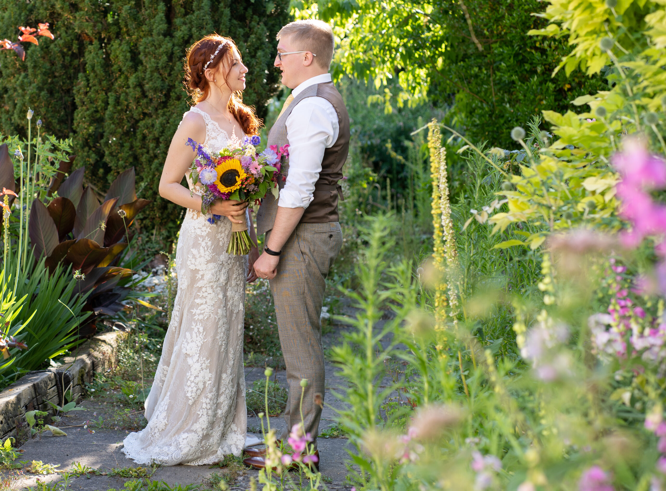 wedding couple looking at each other in garden