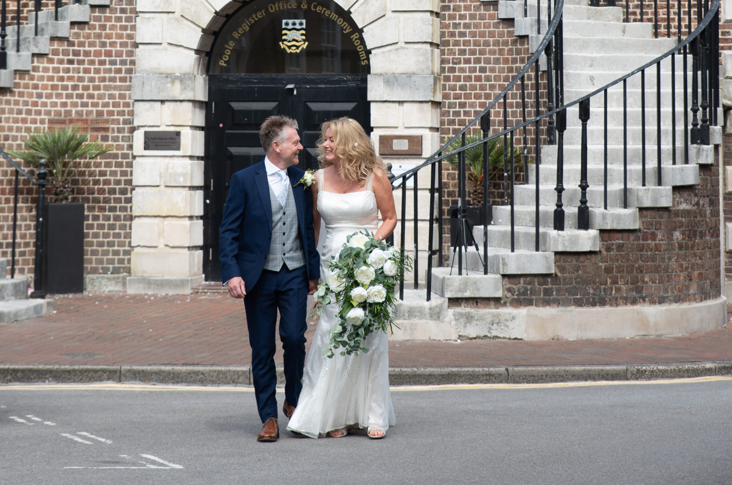 Couple leaving Poole registry office after a wedding with Bournemouth wedding photographer